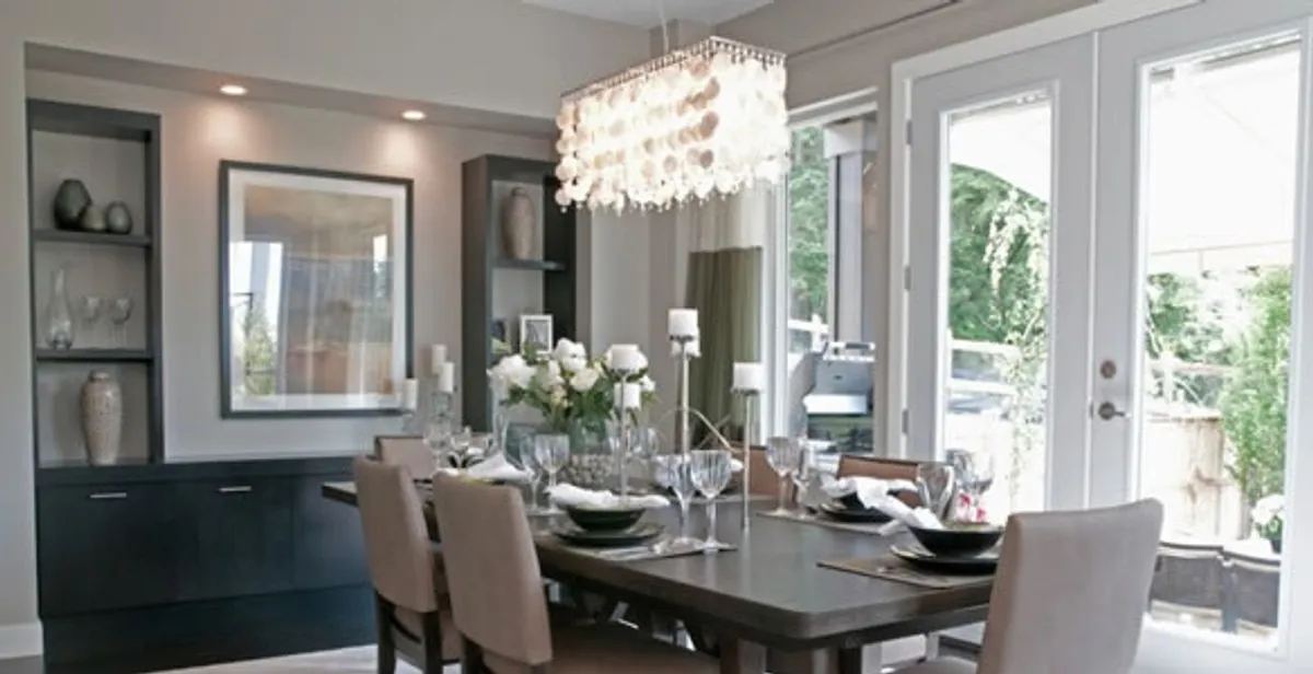 Elegant dining room chandelier installation above table in San Diego, CA